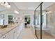 Bright bathroom features dual sinks with granite countertops, a glass-enclosed shower, and a soaking tub at 3525 Montebello Pkwy, Cumming, GA 30028