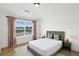 Bedroom with hardwood floors, pink curtains, ceiling fan, and view to the exterior at 3525 Montebello Pkwy, Cumming, GA 30028
