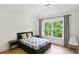 Bedroom with hardwood floors, a ceiling fan, white walls and view to the exterior at 3525 Montebello Pkwy, Cumming, GA 30028