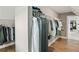 A walk-in closet features hardwood floors, wire shelving, and neatly organized clothing at 3525 Montebello Pkwy, Cumming, GA 30028
