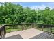Spacious wooden deck overlooking lush green trees, perfect for enjoying nature and outdoor relaxation at 3525 Montebello Pkwy, Cumming, GA 30028