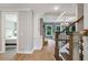 Inviting foyer with hardwood floors, staircase, and view into the bedroom and living room with coffered ceilings at 3525 Montebello Pkwy, Cumming, GA 30028