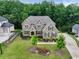 A beautifully landscaped lawn surrounds this elegant home with a side entry garage at 3525 Montebello Pkwy, Cumming, GA 30028