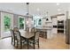 Modern kitchen features an island, stainless steel appliances, and a connected dining area at 3525 Montebello Pkwy, Cumming, GA 30028