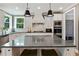 Spacious kitchen island with bar seating, stainless appliances, granite countertops, and white shaker cabinetry at 3525 Montebello Pkwy, Cumming, GA 30028
