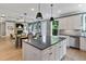 A large kitchen with center island opens to the dining and living rooms in an open floor plan at 3525 Montebello Pkwy, Cumming, GA 30028