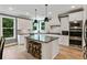 Well-appointed kitchen featuring a center island with bar seating, stainless appliances, and ample natural light at 3525 Montebello Pkwy, Cumming, GA 30028