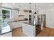 A large kitchen features a center island, stainless appliances, white cabinets, and a view from the window at 3525 Montebello Pkwy, Cumming, GA 30028