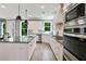A spacious kitchen features granite counters, stainless appliances, white cabinets, and a center island at 3525 Montebello Pkwy, Cumming, GA 30028