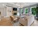 Comfortable living room boasts coffered ceilings, a stone fireplace, and windows with beautiful views of the trees at 3525 Montebello Pkwy, Cumming, GA 30028