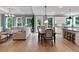 Open-concept living space with a kitchen, dining area, and living room featuring hardwood floors and natural light at 3525 Montebello Pkwy, Cumming, GA 30028