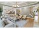 Beautiful open-concept with kitchen, dining, and living areas, featuring hardwood floors, coffered ceilings, and natural light at 3525 Montebello Pkwy, Cumming, GA 30028