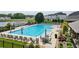 This inviting community pool features plenty of seating, tables, and umbrellas for relaxing in the sun at 3525 Montebello Pkwy, Cumming, GA 30028