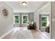 This sitting room features hardwood floors, grey walls, an area rug, and great natural light at 3525 Montebello Pkwy, Cumming, GA 30028