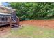 Step onto the deck from a backyard blending lawn and wooded areas at 3780 Summit Gate Dr, Suwanee, GA 30024