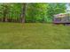 Expansive backyard featuring lush green grass and mature trees for shade and privacy at 3780 Summit Gate Dr, Suwanee, GA 30024