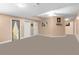 This finished basement has neutral paint, carpet, and multiple white doors at 3780 Summit Gate Dr, Suwanee, GA 30024