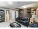 Basement rec room featuring leather furniture and a black and white area rug on the carpet at 3780 Summit Gate Dr, Suwanee, GA 30024