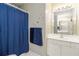 Bathroom with white vanity, blue shower curtain and towels, and large vanity mirror at 3780 Summit Gate Dr, Suwanee, GA 30024