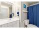 Bright bathroom with blue accents featuring a vanity, toilet and shower with blue curtain at 3780 Summit Gate Dr, Suwanee, GA 30024