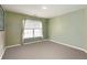 This is a cozy bedroom with carpet flooring, neutral paint, and a window with blinds and curtains at 3780 Summit Gate Dr, Suwanee, GA 30024