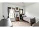 Cozy bedroom with neutral walls, carpeted floor, two windows and a dark wood twin-sized bed at 3780 Summit Gate Dr, Suwanee, GA 30024