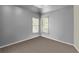 This is a basic bedroom with carpet flooring, neutral paint, and two windows with blinds at 3780 Summit Gate Dr, Suwanee, GA 30024