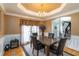 Dining room with marble-top table, decorative wainscotting and adjacent doorway to foyer at 3780 Summit Gate Dr, Suwanee, GA 30024