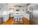 Well-lit kitchen with white cabinets, stainless steel appliances, and a center island at 3780 Summit Gate Dr, Suwanee, GA 30024