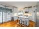 Modern kitchen with white cabinets, stainless steel appliances, and an island with seating at 3780 Summit Gate Dr, Suwanee, GA 30024