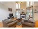 Bright, open-concept living room with a fireplace, hardwood floors, and abundant light at 3780 Summit Gate Dr, Suwanee, GA 30024