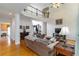 Bright, open-concept living room with a fireplace, hardwood floors, and abundant light and view to dining room at 3780 Summit Gate Dr, Suwanee, GA 30024