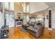 Bright, open-concept living room with a fireplace, hardwood floors, and abundant light at 3780 Summit Gate Dr, Suwanee, GA 30024