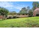 Expansive backyard with lush green lawn, mature trees and shrubbery viewed from a low angle at 3946 Flakes Mill Rd, Decatur, GA 30034