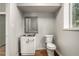 Cozy bathroom featuring a white vanity with brushed nickel hardware and framed mirror over vinyl flooring at 3946 Flakes Mill Rd, Decatur, GA 30034