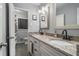 Bathroom with a double vanity, granite countertops, and two framed mirrors at 3946 Flakes Mill Rd, Decatur, GA 30034