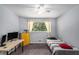 Bedroom with a desk, bright yellow drawers, and natural light from the window at 3946 Flakes Mill Rd, Decatur, GA 30034