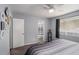 Cozy bedroom featuring a ceiling fan, large window with natural light, and an ensuite bathroom at 3946 Flakes Mill Rd, Decatur, GA 30034