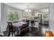 Cozy dining area with modern chandelier lighting and a view into the updated kitchen at 3946 Flakes Mill Rd, Decatur, GA 30034