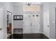 Entryway featuring a double door entrance, coat rack, dark hardwood flooring, and neutral paint at 3946 Flakes Mill Rd, Decatur, GA 30034