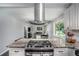 Bright kitchen flows to an adjacent living room, with granite countertops, a range, and stainless steel appliances at 3946 Flakes Mill Rd, Decatur, GA 30034