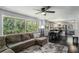 Bright and airy living room with a large window overlooking lush greenery and an open flow to the kitchen at 3946 Flakes Mill Rd, Decatur, GA 30034