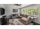 Comfortable living room featuring a large sectional sofa and natural light from the windows at 3946 Flakes Mill Rd, Decatur, GA 30034