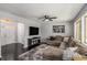 Inviting living room with dark wood floors, large windows, and a comfortable sectional sofa at 3946 Flakes Mill Rd, Decatur, GA 30034
