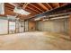 Unfinished basement with exposed beams and access to the backyard at 5545 Durrett Dr, Atlanta, GA 30338