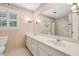 This primary bathroom offers double sinks, vintage wallpaper, and a shower at 5545 Durrett Dr, Atlanta, GA 30338