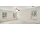 This bedroom has neutral colored carpet, natural light, and shuttered windows at 5545 Durrett Dr, Atlanta, GA 30338