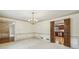 Formal dining area with chandelier and wood trim, connected to kitchen through doorway at 5545 Durrett Dr, Atlanta, GA 30338