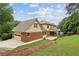 This home features lush landscaping, a driveway, a screened porch, and a two-car garage at 5545 Durrett Dr, Atlanta, GA 30338