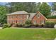 Traditional brick home with neat landscaping and a spacious front lawn, ideal for families at 5545 Durrett Dr, Atlanta, GA 30338
